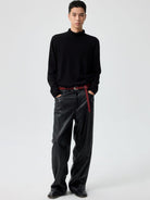 SIMPLE PROJECT Twisted Seam Metallic Faux Leather Trousers in Black - On Male Model