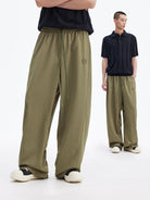 MEDM Lightweight Wide Leg Track Pants in Olive - On Male Model