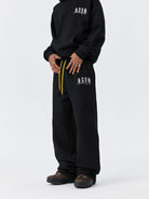 MEDM Fleece Lined Embroidered Sweatpants in Black - On Model