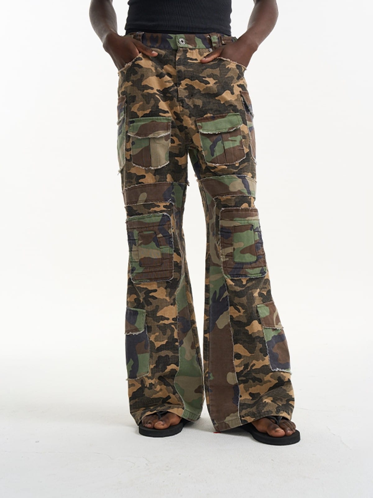 BLINDNOPLAN Paneled Camo Flared Cargo Pants in Green - On Male Model