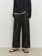 MSBEAST Cropped Wide Leg Leather Trousers in Black - On Model