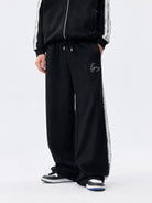 MEDM Lace Paneled Striped Track Pants in Black - On Model