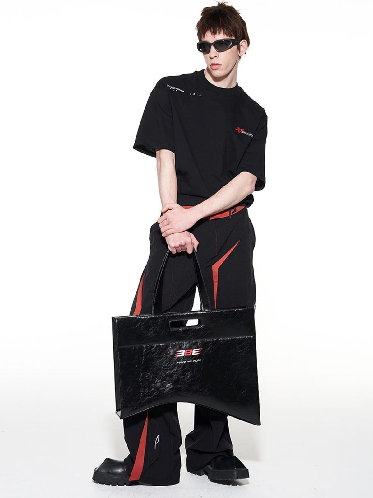 BLINDNOPLAN Textured Faux Leather Asymmetric Tote in Black - On Male Model
