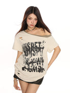 BIGGOLD STUDIO Distressed Graffiti Off Shoulder Tee in Cream - On Model #color_cream - On Female Model