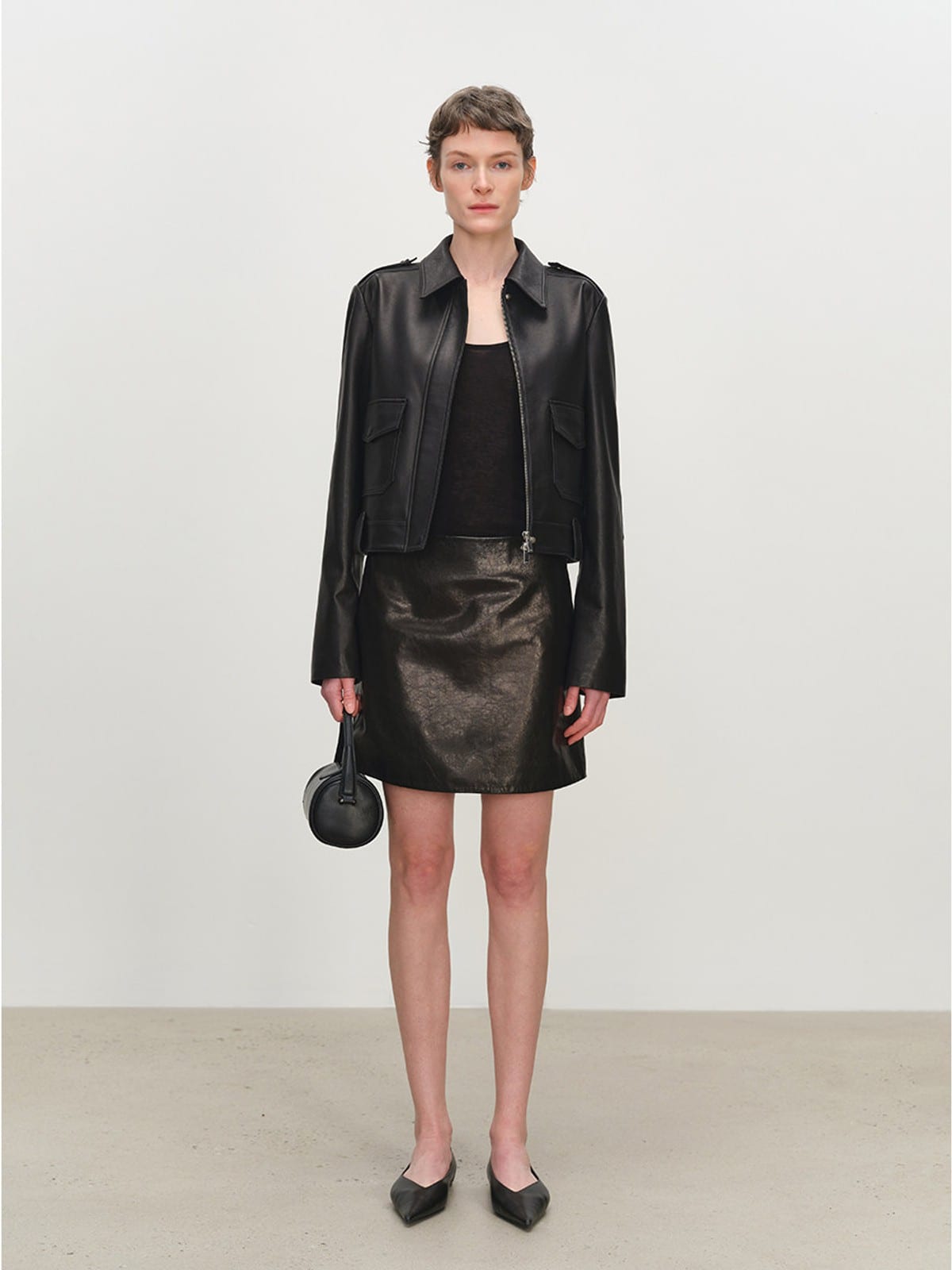 MSBEAST Cropped Sheepskin Moto Jacket in Black - On Female Model