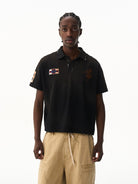 BLINDNOPLAN Distressed Embroidered Cotton Polo in Black - On Male Model