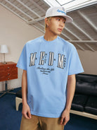 MEDM Pearl Embellished Letter Cotton T Shirt in Sky Blue - On Male Model
