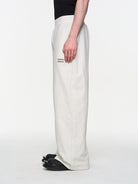 BLINDNOPLAN Foil Logo Cotton Sweatpants in White - On Male Model