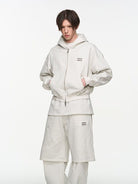 BLINDNOPLAN Metallic Logo Zip Hoodie Pants Set in White - On Male Model