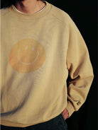 USAGE Washed Cotton Raglan Smiley Sweatshirt in Beige - On Male Model