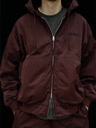 USAGE Crinkle Nylon Hooded Track Jacket in Brown - On Male Model