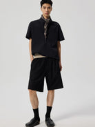 SIMPLE PROJECT Logo Tape Wool Blend Shorts in Black - On Male Model
