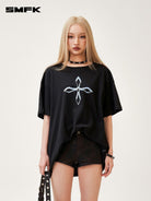 SMFK Cross Graphic Cotton T Shirt in Black - On Female Model