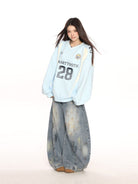 Big Gold studio V Neck Graphic Jersey Sweatshirt in Sky Blue - On Female Model