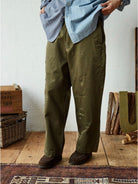 USAGE Hand Distressed Patched Chinos in Olive - On Male Model