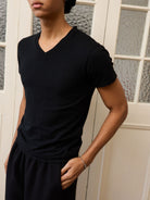Retro 21 Anti Wrinkle V Neck T Shirt in Black - On Male Model