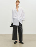 MSBEAST Cropped Wide Leg Leather Trousers in Black - On Female Model