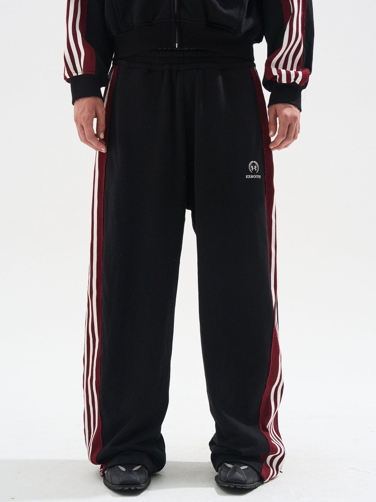 BLINDNOPLAN Raw Edge Contrast Paneled Sweatpants in Black - On Male Model