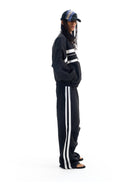 BLINDNOPLAN Striped Pleated Track Pants in Black - On Model