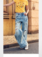 BeerBro Distressed Dirty Wash Relaxed Jeans in Blue - On Female Model