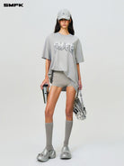 SMFK Metallic Logo Cotton T Shirt in Gray - On Female Model