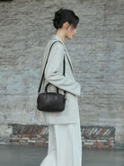 QIUZHEN Vegetable Tanned Leather Bowling Bag in Brown - On Female Model