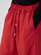 SIMPLE PROJECT Pleated Wide Leg Nylon Pants in Red - On Model