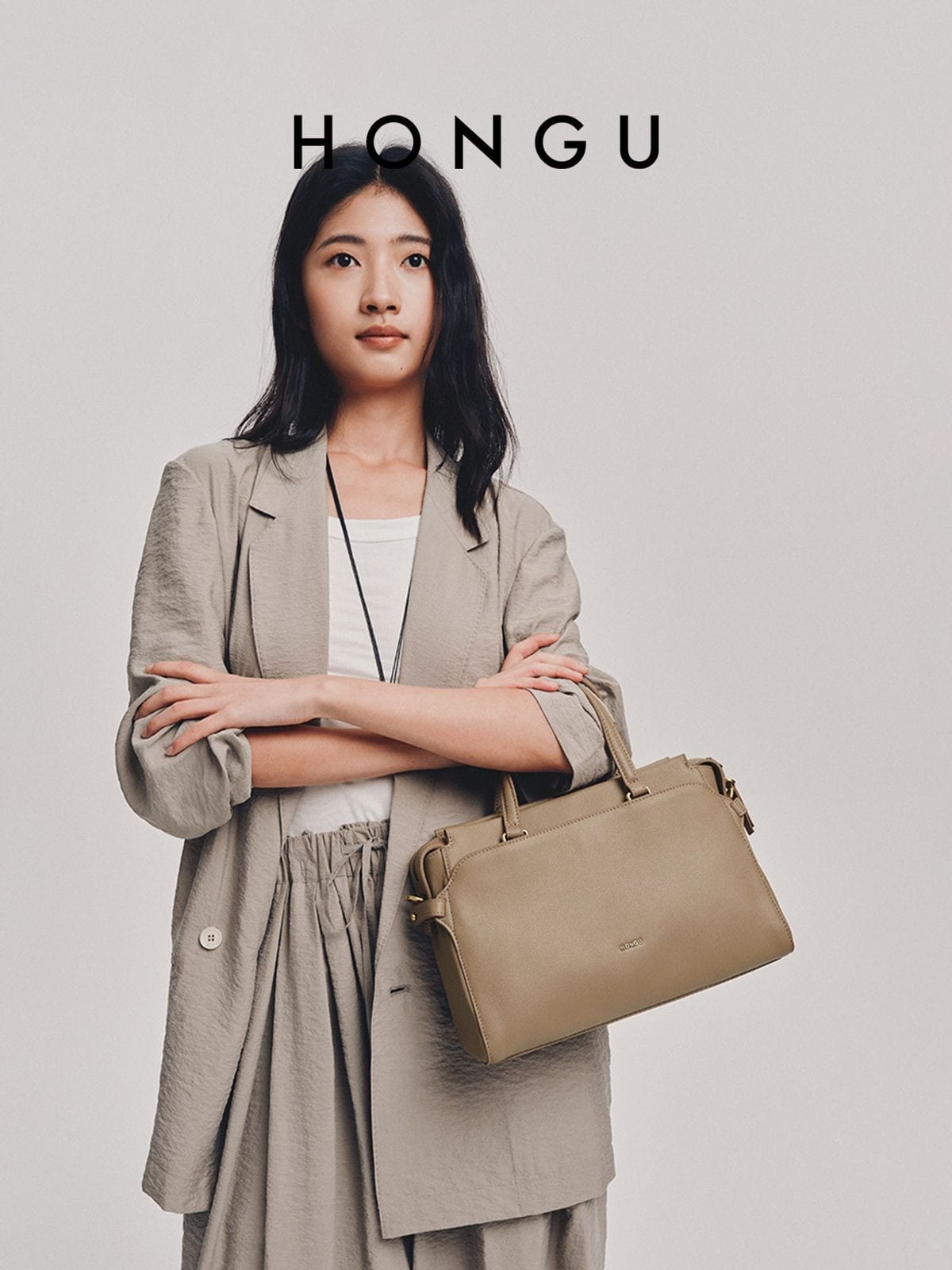 HONGU Structured Leather Top Handle Bag in Beige - On Female Model