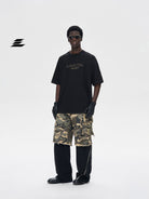LOSTCTRL Heavyweight Cotton Rivet Logo T Shirt in Black - On Male Model