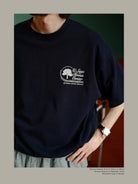 USAGE Retro Tennis Graphic Cotton T Shirt in Navy Blue - On Male Model