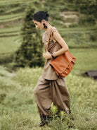 QIUZHEN Vegetable Tanned Leather Messenger Bag in Brown - On Female Model