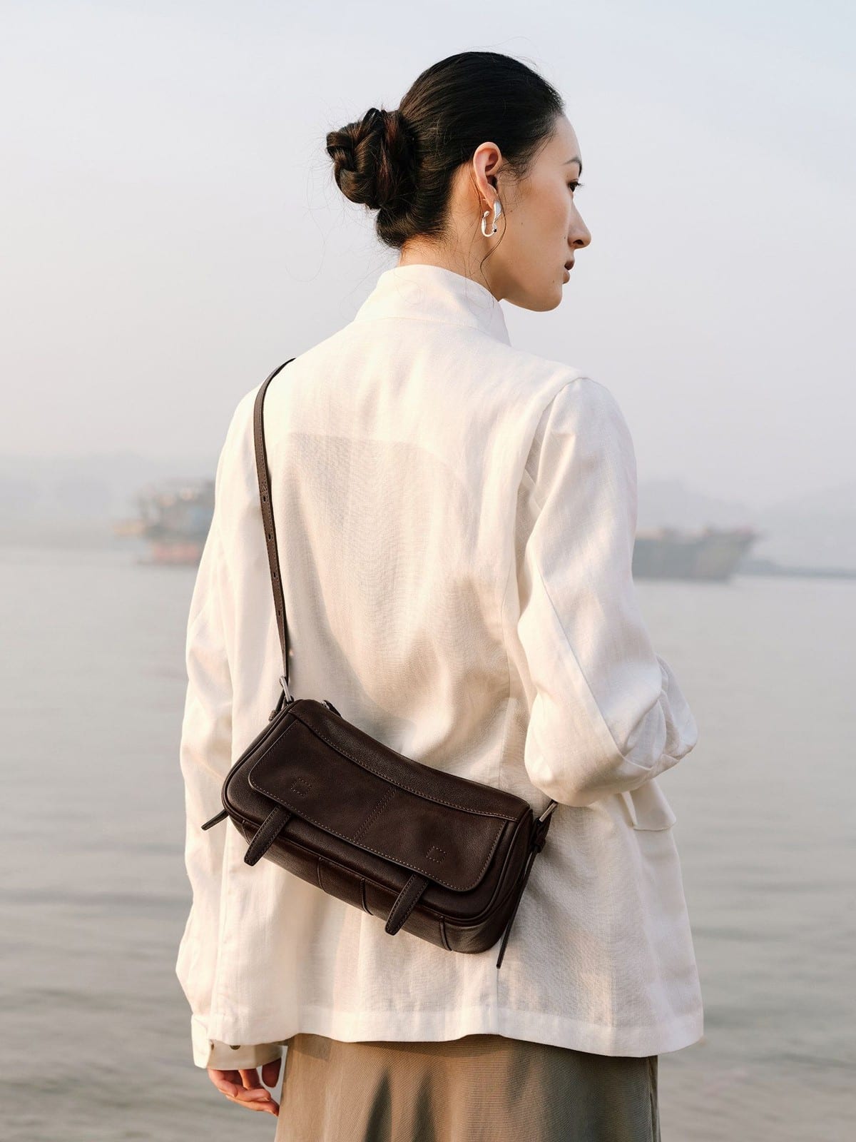 QIUZHEN Vegetable Tanned Leather Camera Bag in Brown - On Female Model