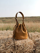 QIUZHEN Kidskin Drawstring Bucket Bag in Brown - Lifestyle