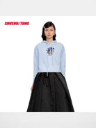 SHUSHUTONG Floral Graphic Knit Hoodie in Sky Blue - On Female Model