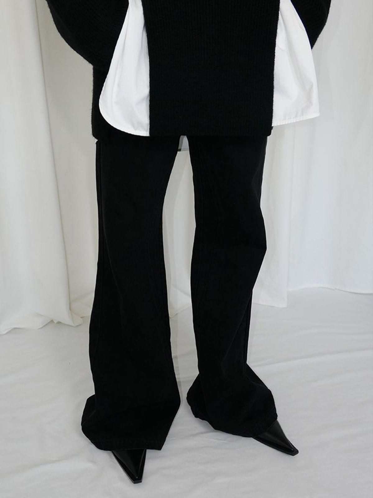 RARELY ALIKE Curved Seam Denim Flare Jeans in Black - On Model