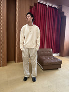 TRIANGLE PROJECT Ribbed Cotton Henley Sweatshirt in White - On Male Model