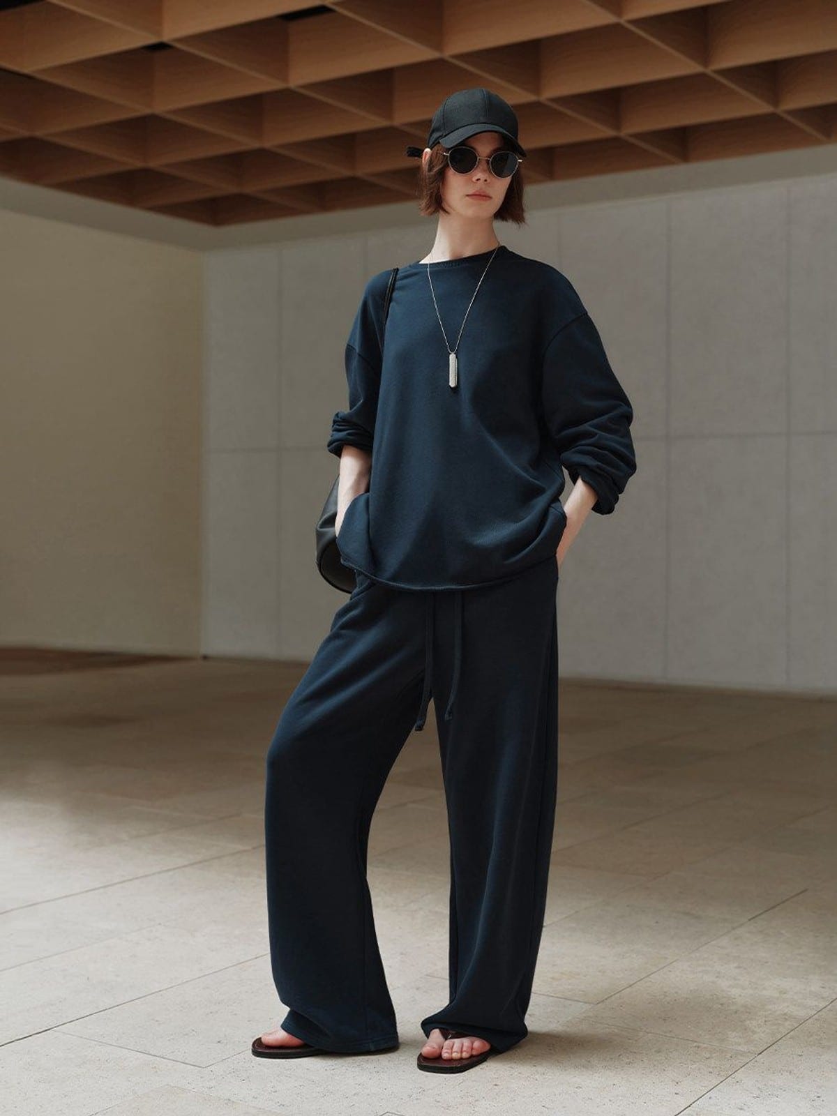 MSBEAST Cotton Terry Sweatshirt Tapered Joggers in Navy Blue - On Female Model