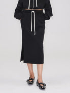 RARELY ALIKE Cotton Side Slit Midi Skirt in Black - On Female Model