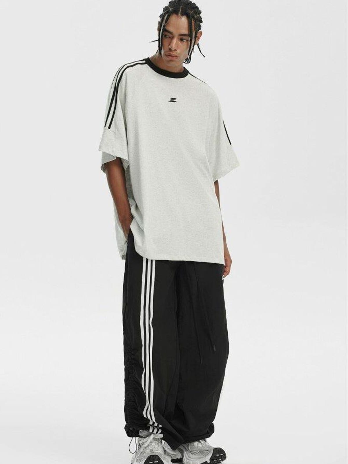 LOSTCTRL Ruched Asymmetrical Striped Track Pants in Black - On Male Model