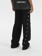 LOSTCTRL Asymmetrical Snap Button Cotton Pants in Black - On Model