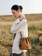 QIUZHEN Kidskin Drawstring Bucket Bag in Brown - On Female Model