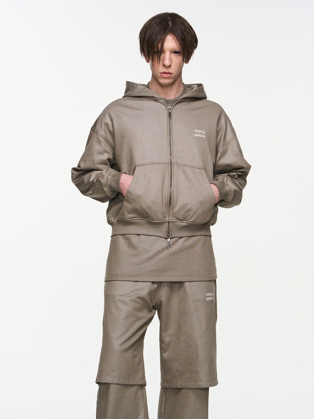 BLINDNOPLAN Foil Logo Cotton Sweatpants in Beige - On Male Model