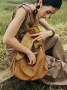 QIUZHEN Vegetable Tanned Leather Messenger Bag in Brown - On Female Model