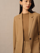 TEASEL Merino Wool Pleated Trousers in Brown - On Female Model
