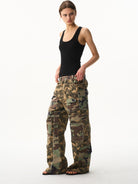 BLINDNOPLAN Paneled Camo Flared Cargo Pants in Green - On Female Model