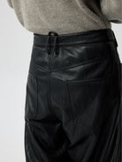 SIMPLE PROJECT Twisted Seam Metallic Faux Leather Trousers in Black - On Model