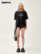 SMFK Cross Graphic Cotton T Shirt in Black - On Female Model