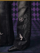 MEDM Icon Embroidered Distressed Jeans in Black - On Model