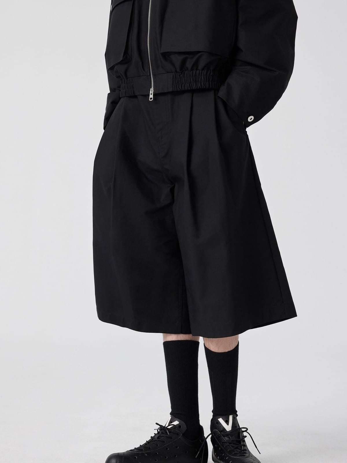 SIMPLE PROJECT Cotton Pleated Cropped Shorts in Black - On Male Model