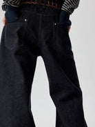 SIMPLE PROJECT Raw Selvedge Boot Cut Jeans in Navy - On Model